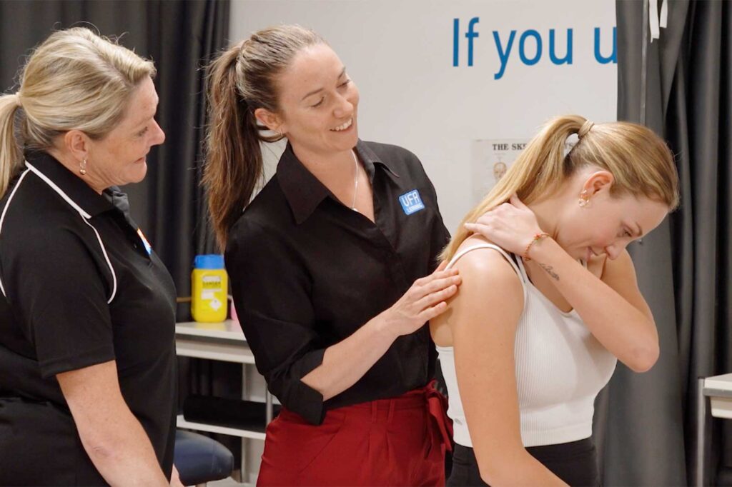 VFA expert massage trainer Jo Timberlake demonstrating massage technique to a student